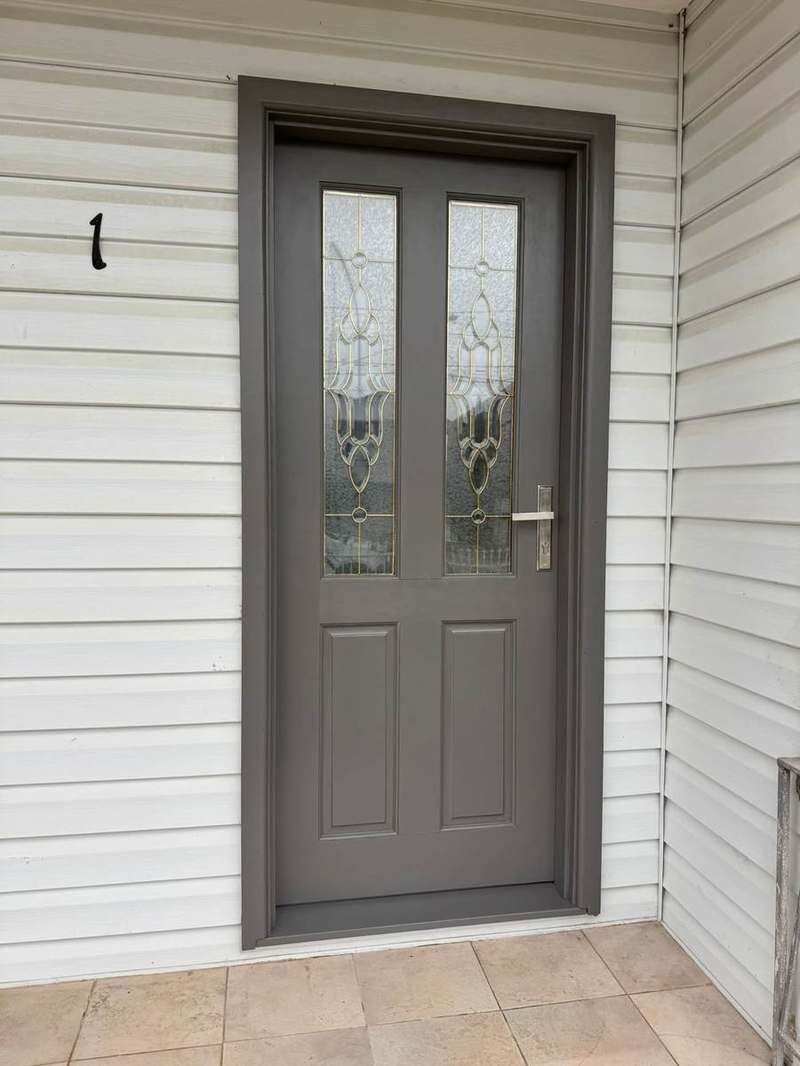 New glass-panel front door after installation and paint