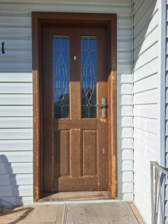 Old worn front door before replacement